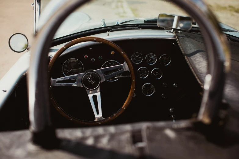 a steering wheel and dashboard of a classic race car