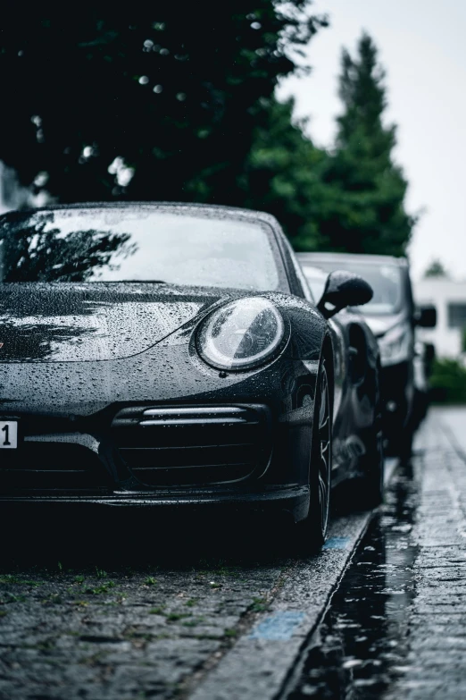 three black cars are sitting on the side of the road