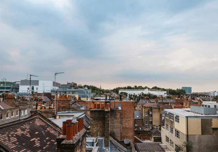 a po of rooftops and buildings with a city in the background