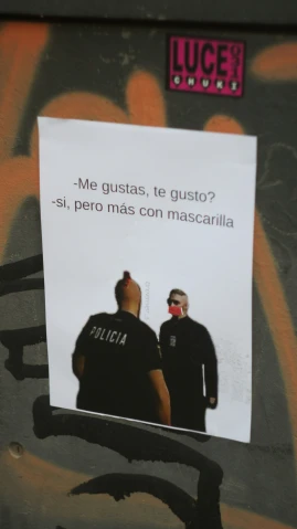 two men wearing black are on a grafitti