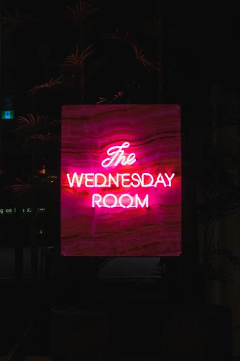a large neon sign that says the wednesday room