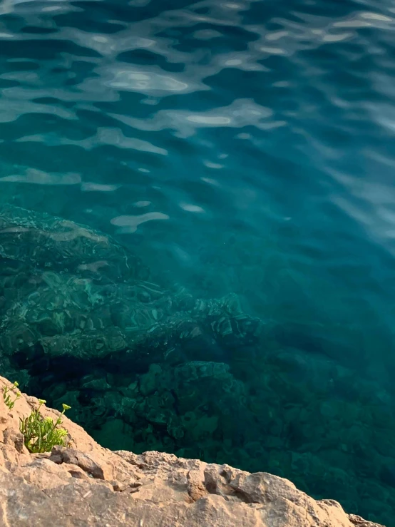 a close up of some blue water with rocks