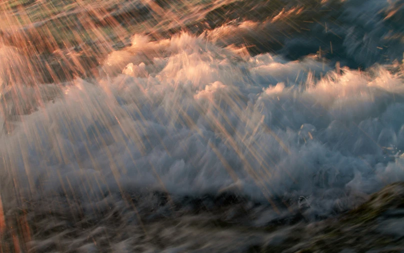 an orange colored image of a wave coming down