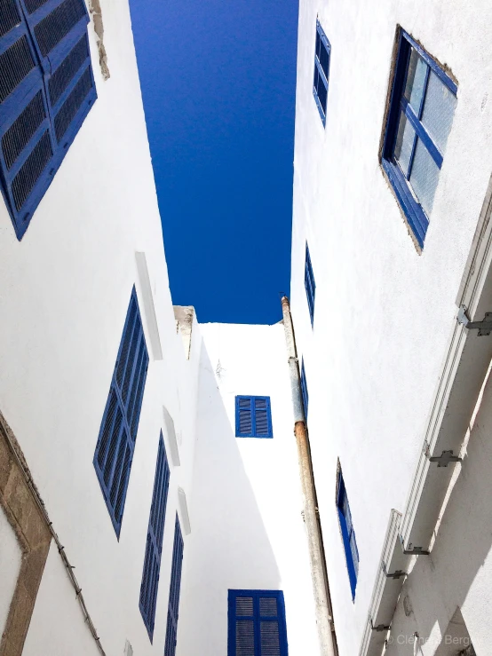 blue and white buildings against a deep blue sky