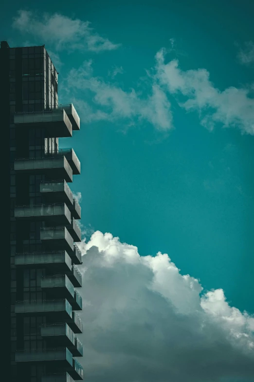 highrise office building with jet flying through cloudy sky