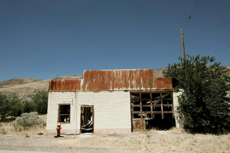 an old run down white and rusted building