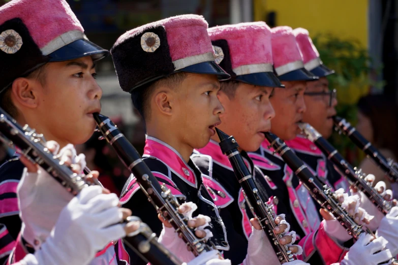 the young members are playing their instruments together