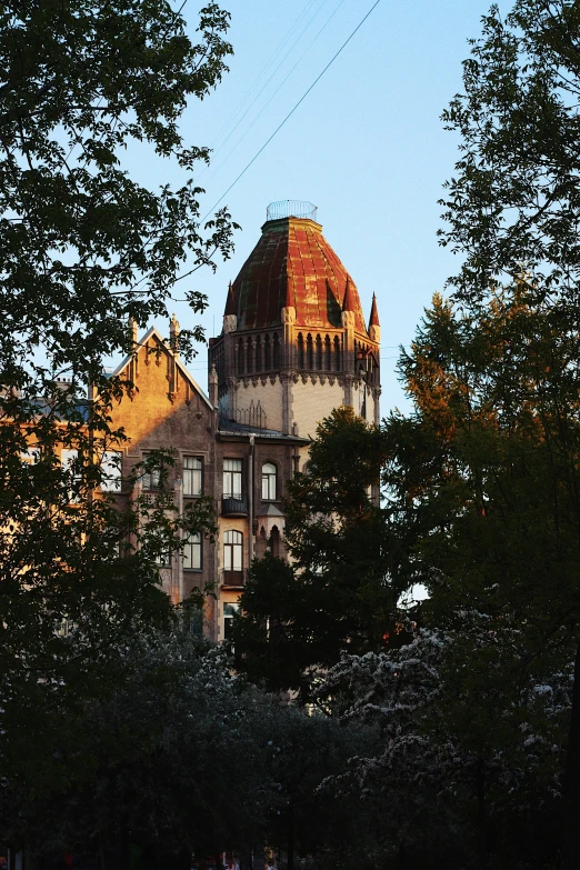 a building with a clock tower sits amid trees