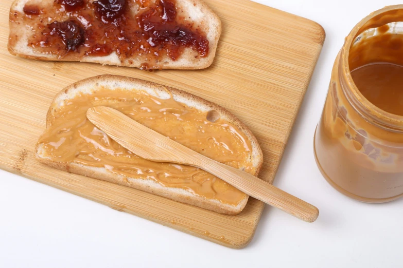 peanut er and jelly sandwich on wooden chopping board