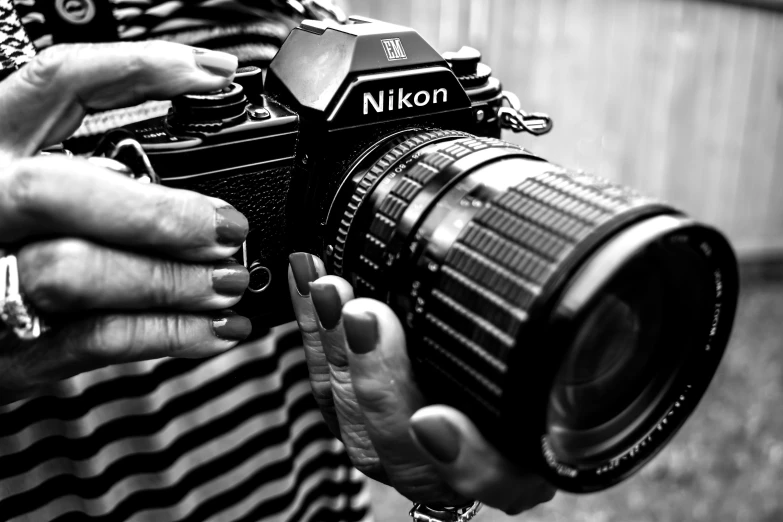 a woman holding a camera in front of her