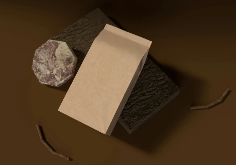 an empty brown paper bag next to a rock on brown material