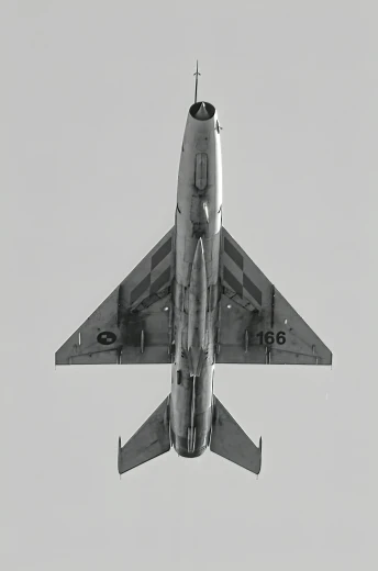 a fighter jet flying through the air with its landing gear down