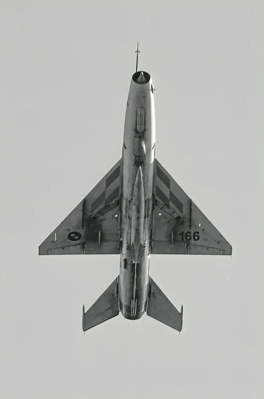 a fighter jet flying through the air with its landing gear down