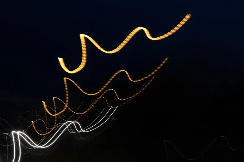 a street sign is displayed with lights at night