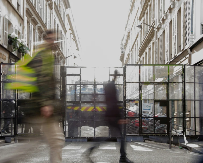 a blurry pograph of a man walking down a city street