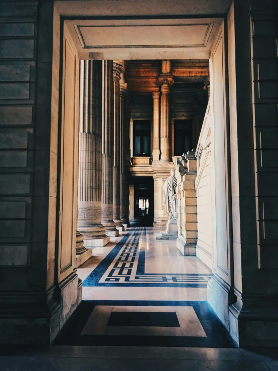 a marble staircase leading up to a window with columns and pillars