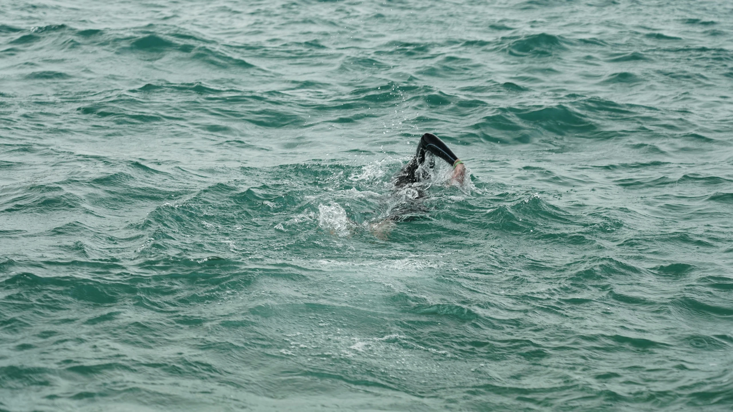 person riding on top of a surf board in the ocean