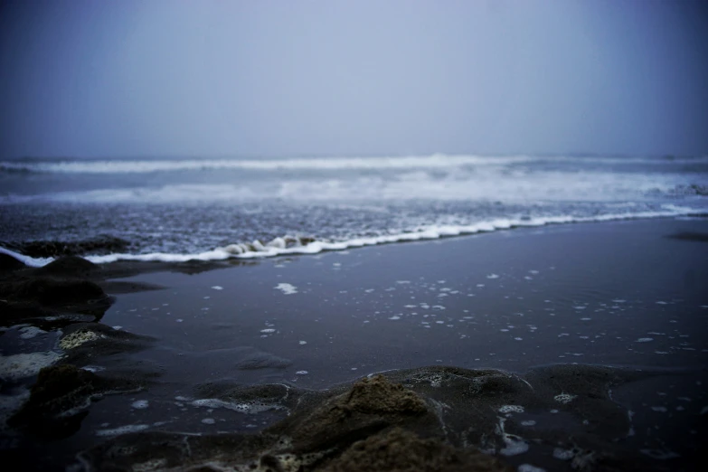 the waves come ashore from the beach in a stormy day