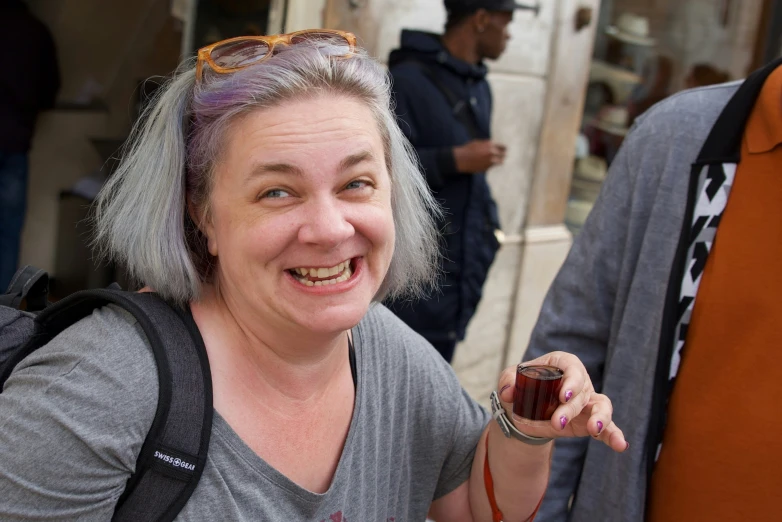 a woman holding a small piece of chocolate cake