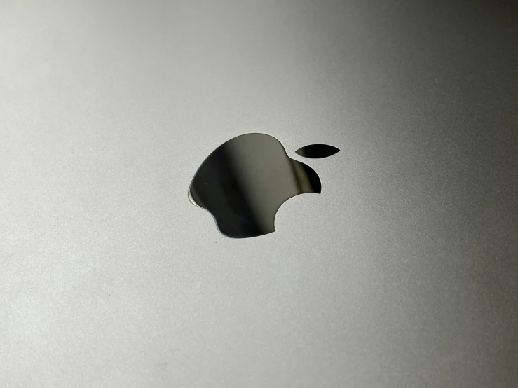 a gray apple laptop computer on top of a white background