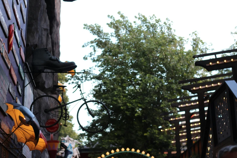 a pair of bikes parked against a wall with lights and signs around it