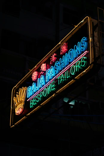 a neon sign that says thai fashions and resort hair stores