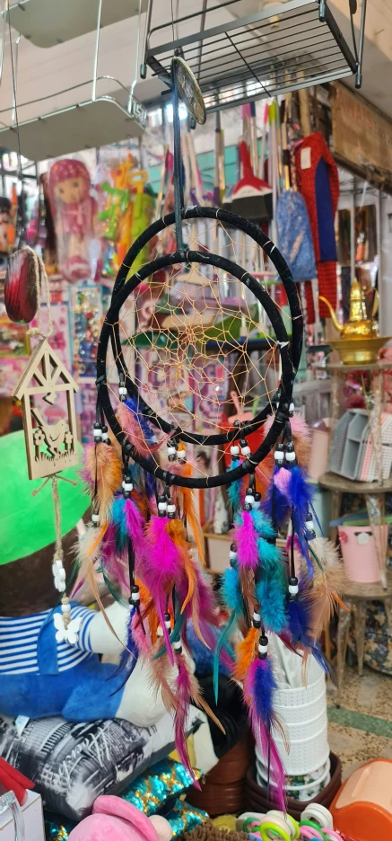 a dream catcher is hanging in a shop with other items