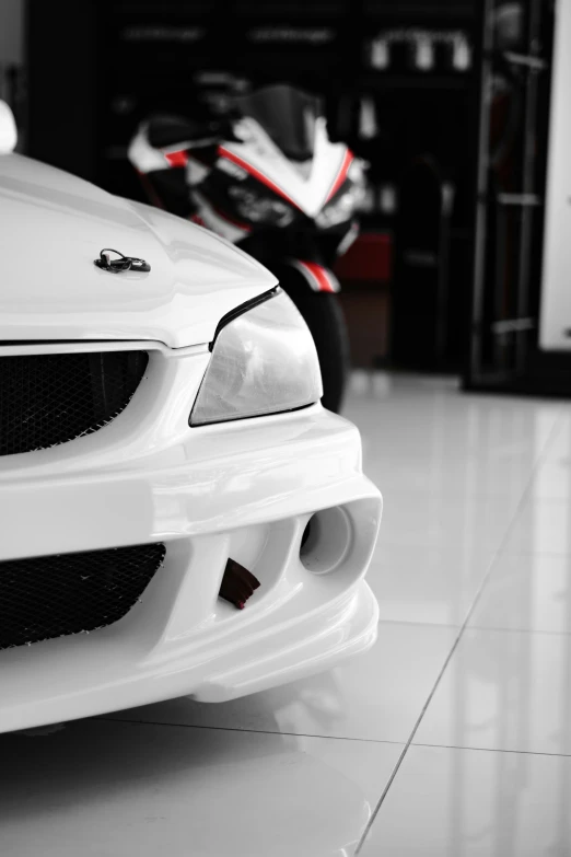 a close up of the front of a white sports car