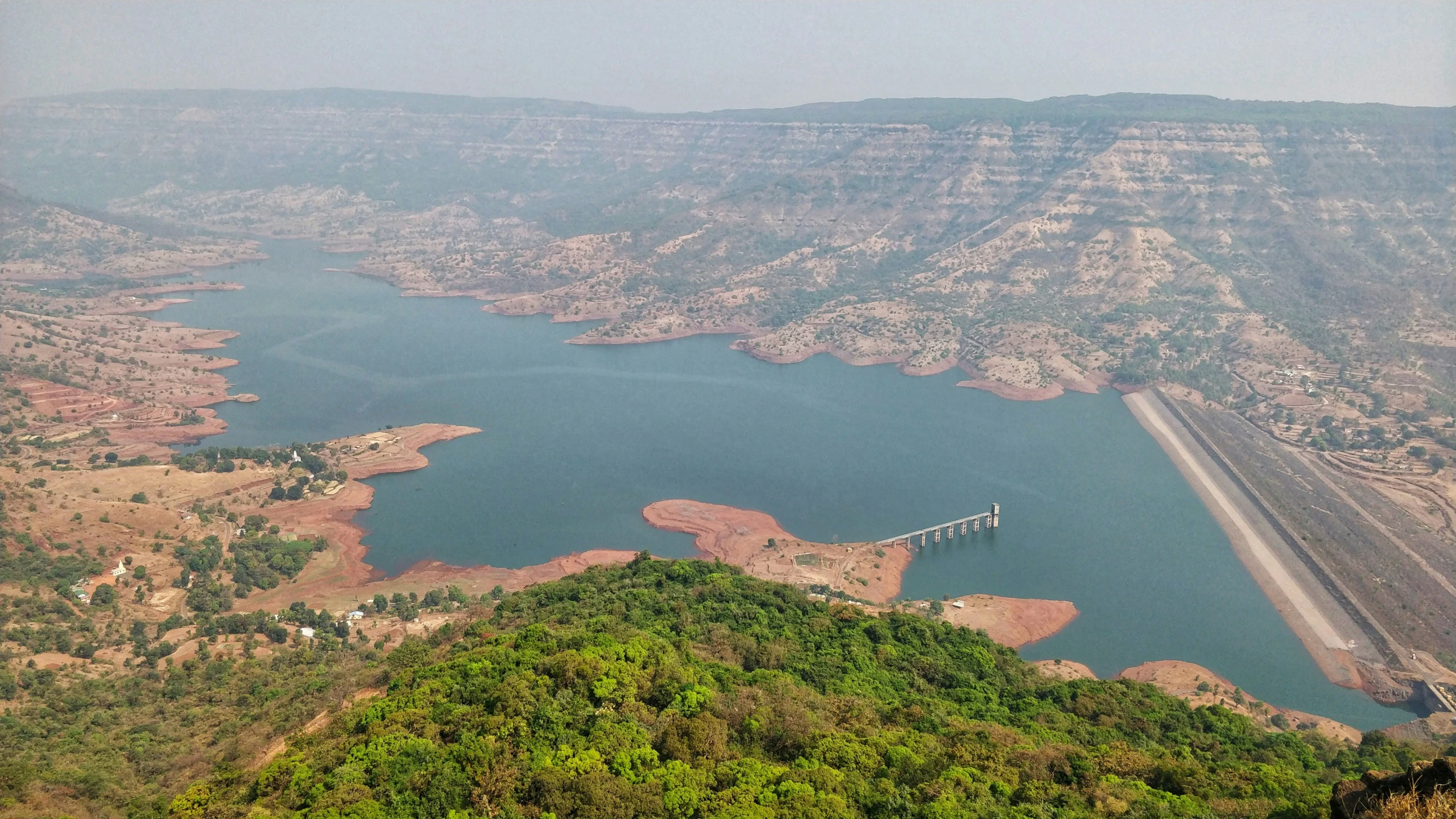 a view of some large hills and some water