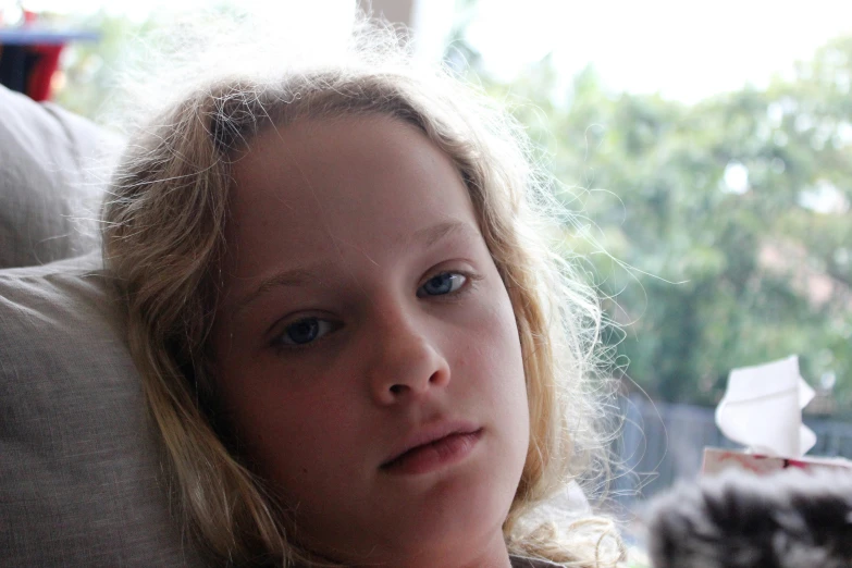 a close up of a person sitting at a table