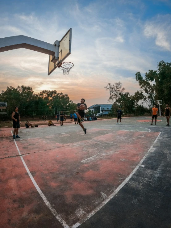 a man jumping to grab a basketball in the air