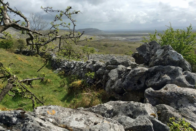 a very cute large rock wall on a big hill