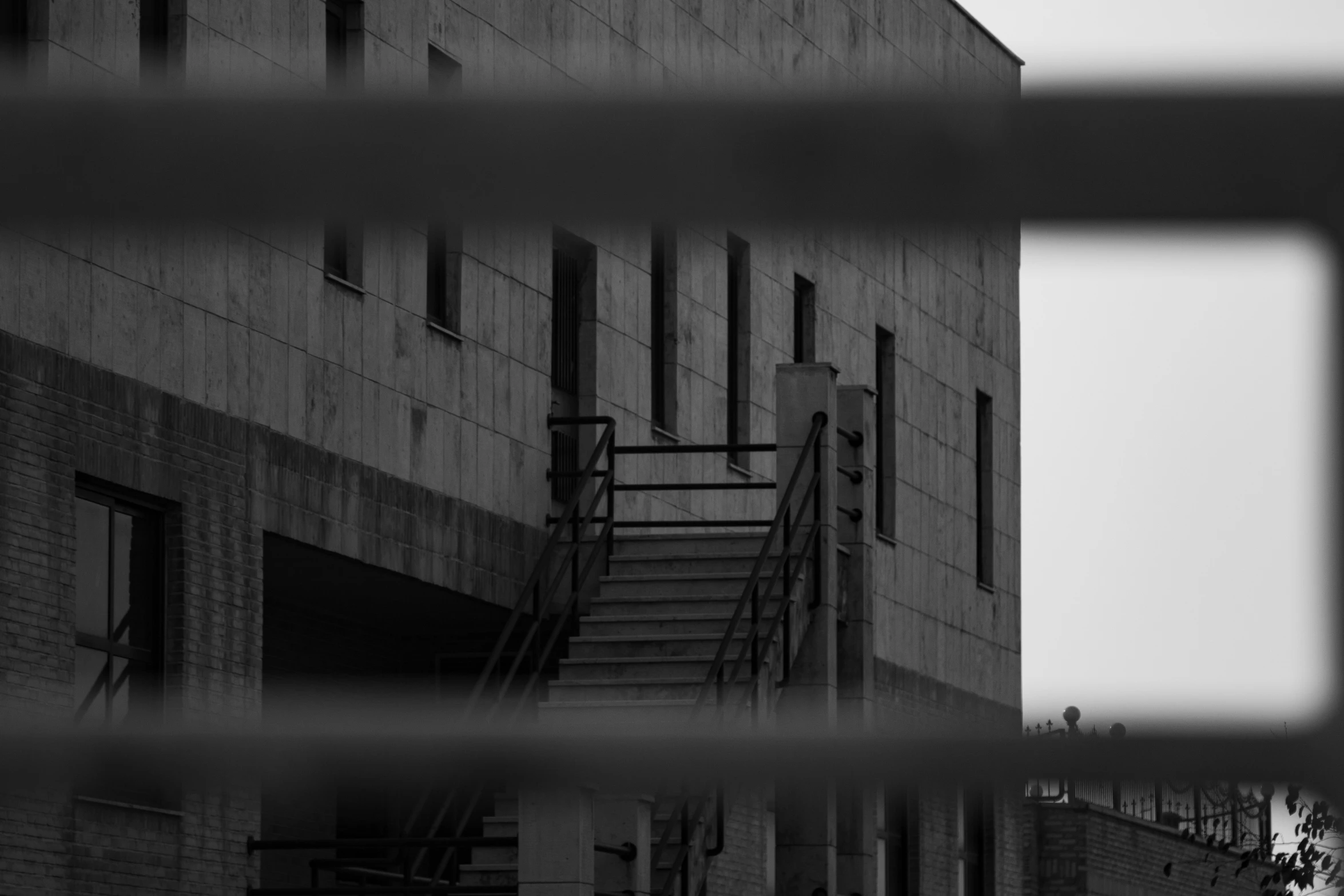 an industrial building with a fire escape on the ground