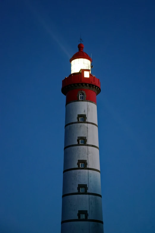 a po taken of a very tall red and white light house