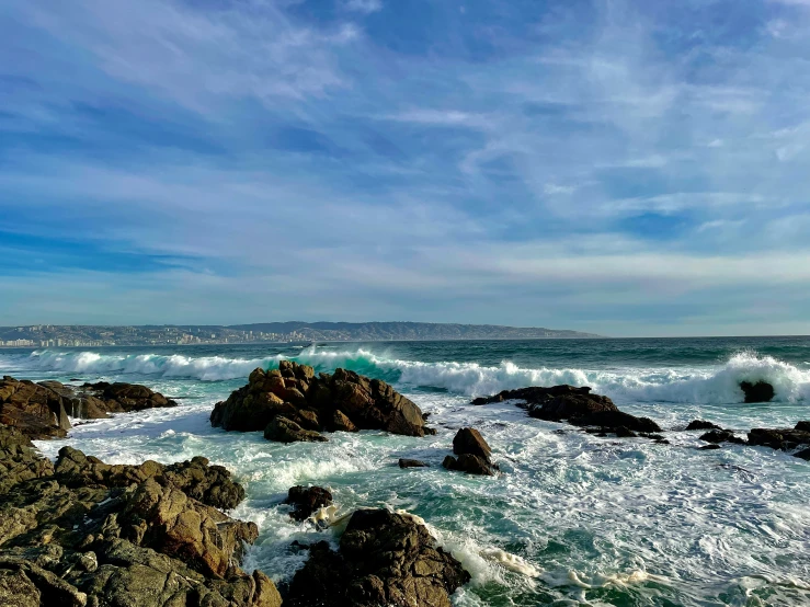 there are many rocks along this beach by the water