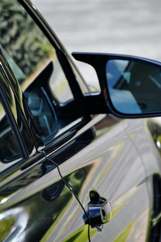 the window of a parked car is shown in reflection