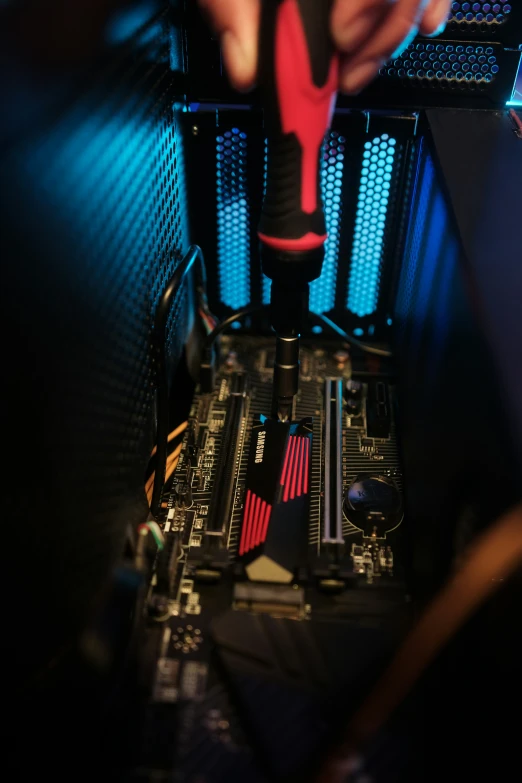 a computer being tested by a technician with colorful lights