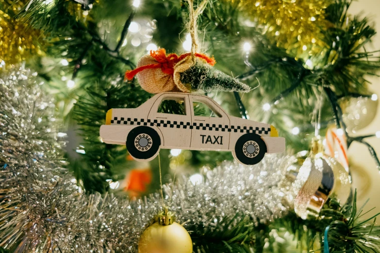 a christmas tree decorated with christmas decorations and a taxi
