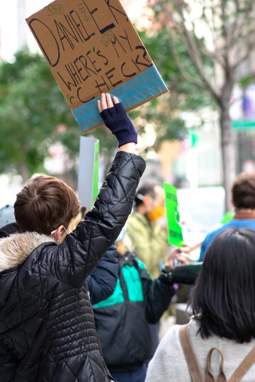 woman holding up sign that reads, daniels where we are