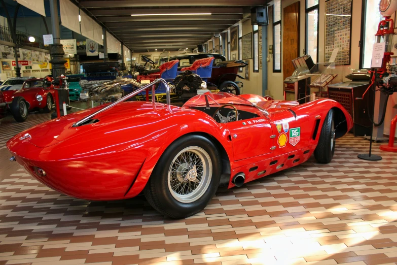 the red race car is in a show room