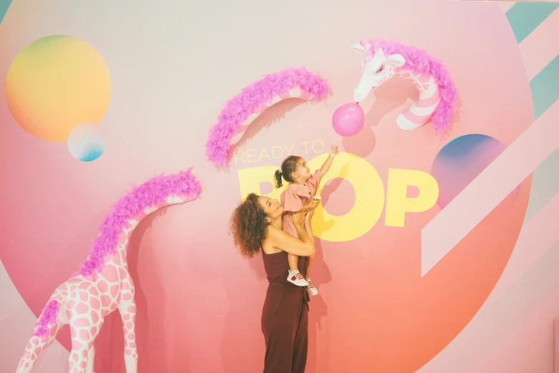 two woman on a stage with an animal themed backdrop