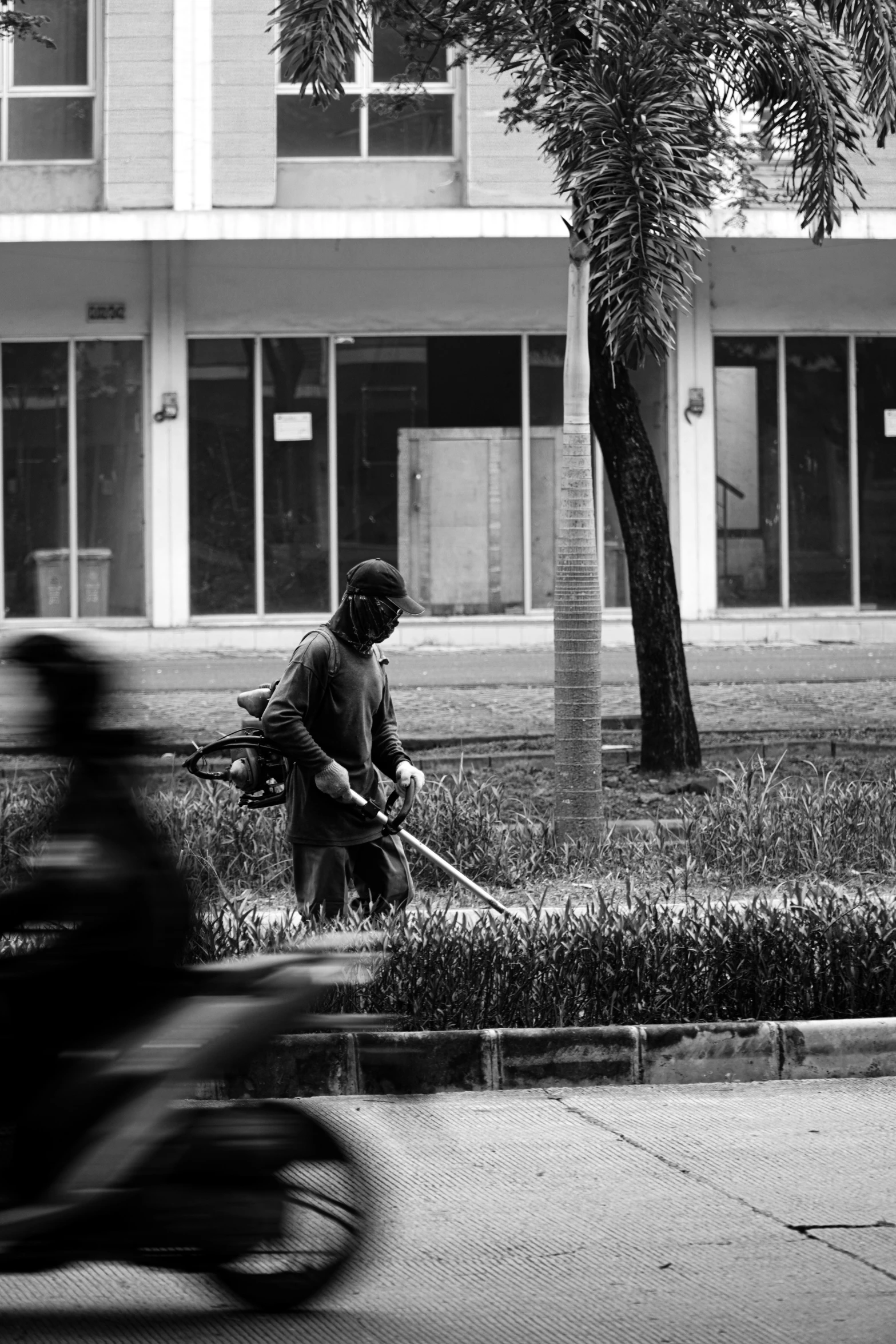 the person is driving his bicycle towards an older building