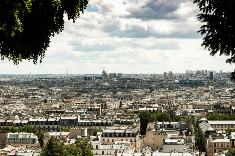 a city with buildings, clouds and trees