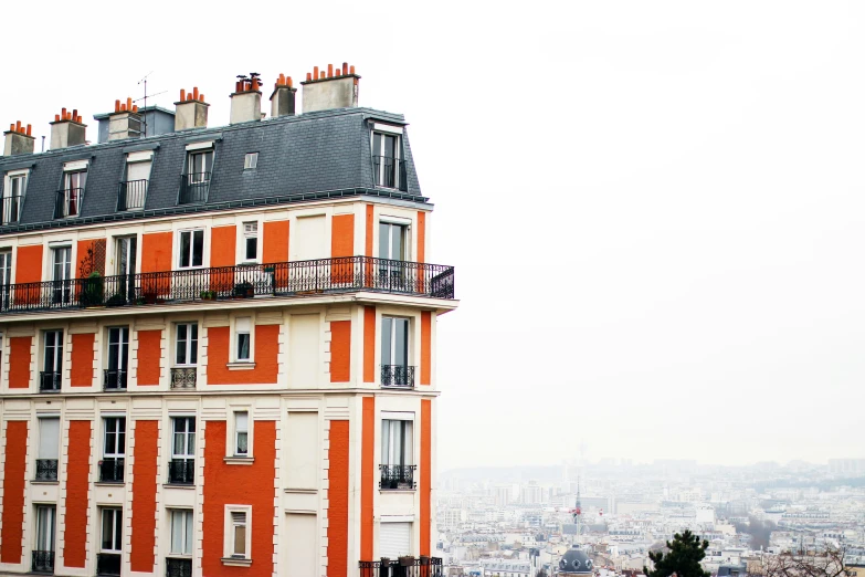 an orange brick building in paris, with the eiffel tower visible behind