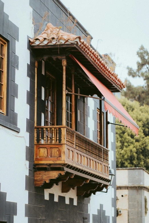 an old wooden balcony on the side of a building