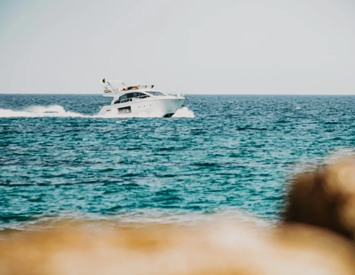 boat in the ocean coming up to shore with waves