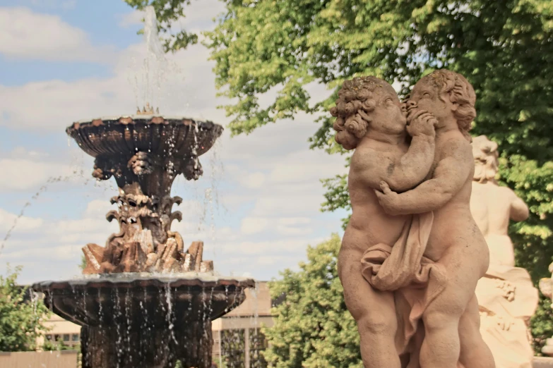 a fountain surrounded by a couple of statues