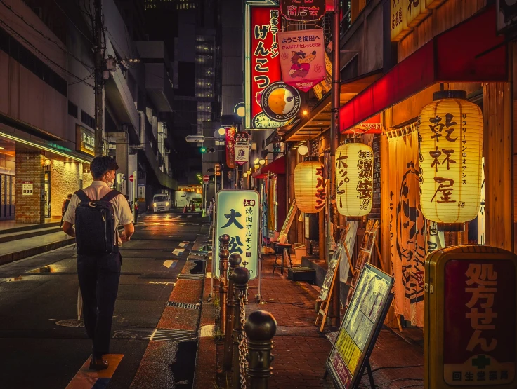 a woman walking down the street at night in asian city