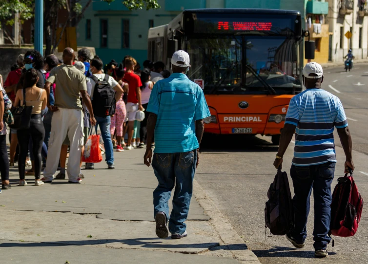 a group of people with back packs crossing the street