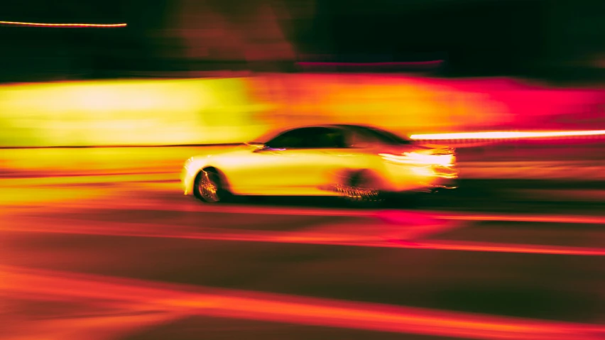 a car speeding down the street with motion blur